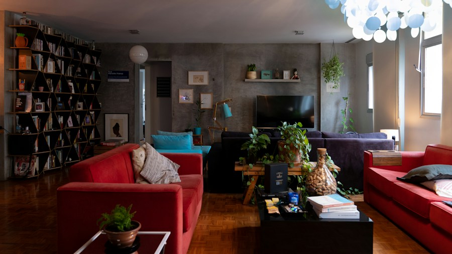 Colored Bookshelf Trend Is Replacing Plain White Shelving: What Shoppers Need to Know 1 bold red bookcase living room