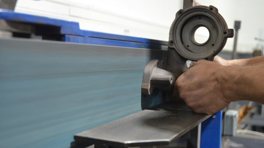 Milwaukee M12 Fuel Scroll Shear Brings Cordless Sheet Metal Cutting to the Jobsite 1 close-up hands using power shear on metal