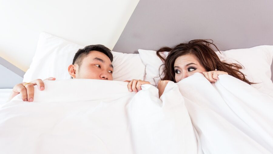 couple sleeping in bed motion isolation