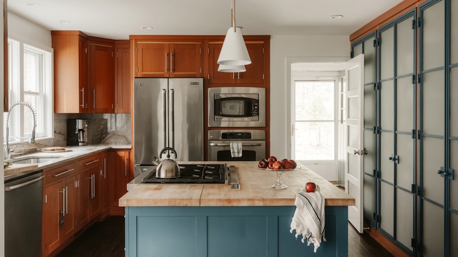 Dark Paint Color Defies the Rules and Makes a Small Kitchen Feel Twice as Big 1 dark blue cabinet kitchen white walls