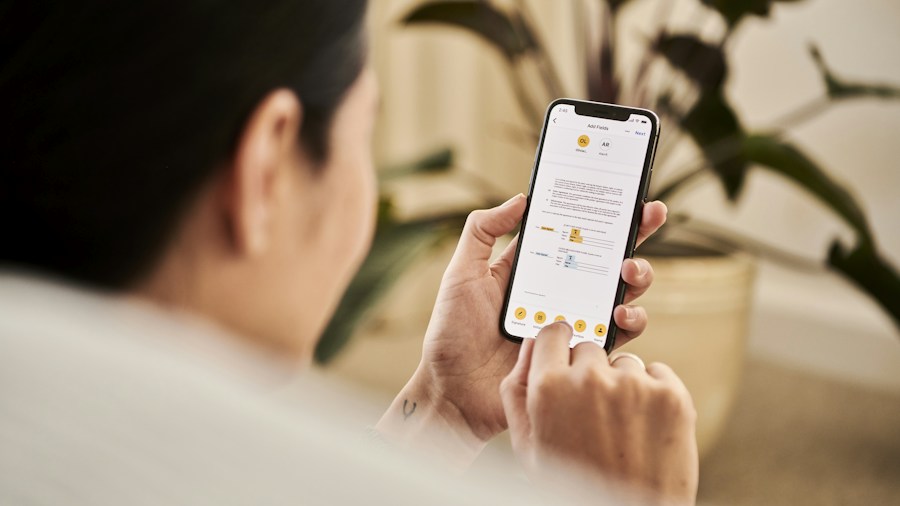 Apple's Smart Thermostat Launch Reshapes the Industry: What Buyers Should Know 1 homeowner checking thermostat on smartphone app