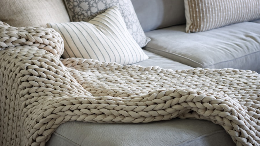 Gray Sofas Trend for 2027: What Homeowners Need to Know 1 layered throw pillows textured blankets sofa