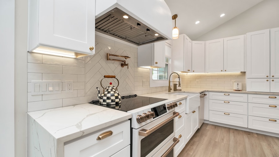 Paint Color Transforms Dated 2000s Kitchen into Modern Scandinavian Space for Budget Price 2 marble gold tile backsplash kitchen