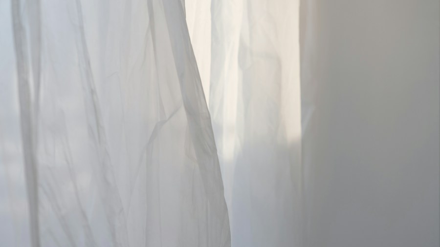 natural light filtering through white curtains