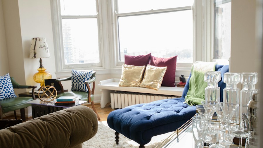 neutral living room with colorful cushions