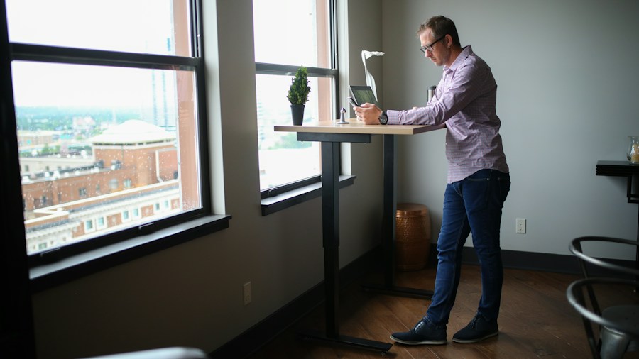 Logitech Pebble Up Mouse Transforms for Ergonomic Relief: What Shoppers Need to Know 1 person typing at standing desk